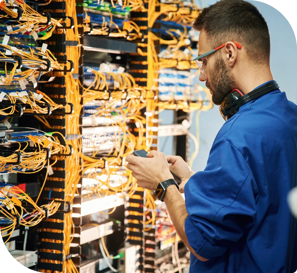 Man working with network cables in server room.