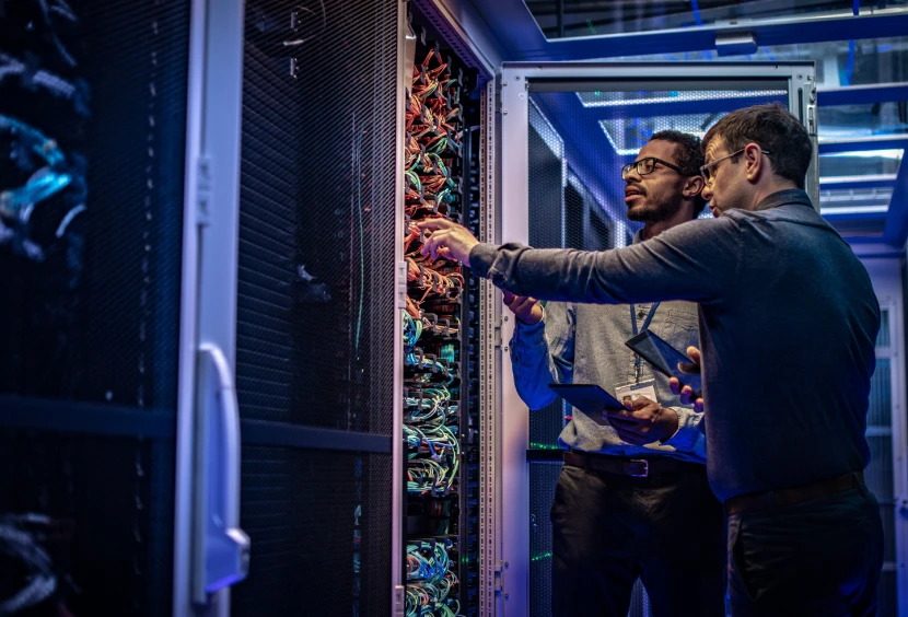Two technicians working in a server room.